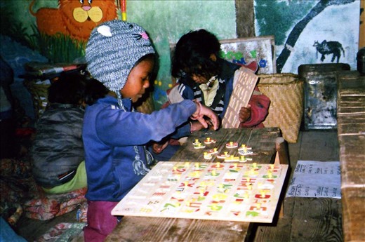 Dipia (Grade 2) is wearing the teachers hat for the day (the beanie is made to look like a mouse and the kids think it is brilliant to get to wear the hat for a day) - that means she gets to help out in class...... here she is having her first go at the new ABC board.
