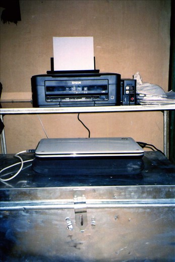 New printer setup in  peAk  building. The printer table (made by Scott) utilised a 'maufacturing defect' solar plate that had been kicking around for years. The tin trunk the new laptop sits on was also used to cart goods via mule into the valley.