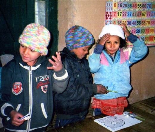 if the beanie fits - wear it! The kids trying on a Granny Girl Guide beanie lovingly knitted in Western Australia.... they were so grateful to have a new beanie.  This coincided with getting some pencils, pen, rubber, cutter etc. 