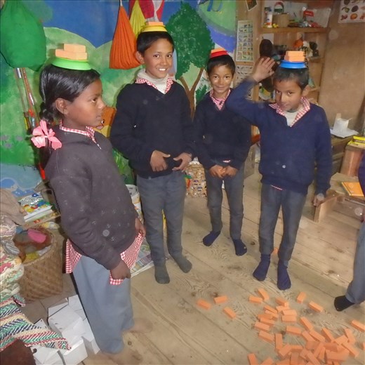 Diviya, Deepak, Mona & Surech still left standing in the 'topi wallah' game. A hugely popular game that requires you to balance blocks on your hat (topi) the last one left standing wins.