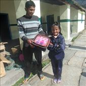 Praveen (community teacher at Jatoli) about to hand Munju her new school bag.: by bonnie, Views[370]
