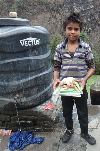 This boy is eleven and works full time. On Sunday he is found washing his clothes. He was so excited about the books and was also keen to learn written Hindi. At informal classes he was doing just that and was very proud of himself!