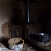 A stove (chulha) nearing completion. In the foreground is a pot full of 'lal mart' (red clay) used for rendering the unit.: by bonnie, Views[479]