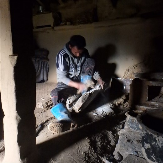 Dinesh hard at work on stove construction.