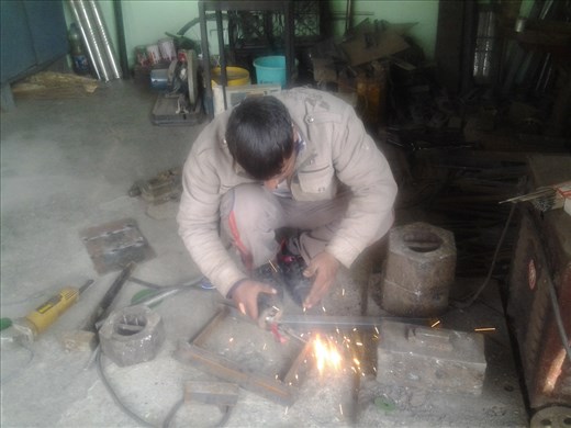 Sharaz working on metal doors for the chulhas