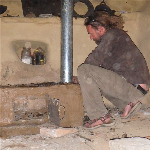 Scott helping out with the flue. Dinesh is on the roof having hammered a hole through the slate roof the flue now needs to be positioned accordingly.