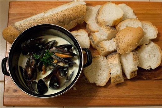 Simply yum! Pot of mussel soup with fresh crusty bread