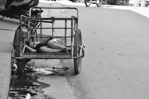 A girl resting in the shadow. As the camera got closer she openned her eyes and looked at it directly, once she felt fear she ran into her house. In Tecun Uman most girls are chosen by walking in the street and are sold or forced to work in prostitution.
