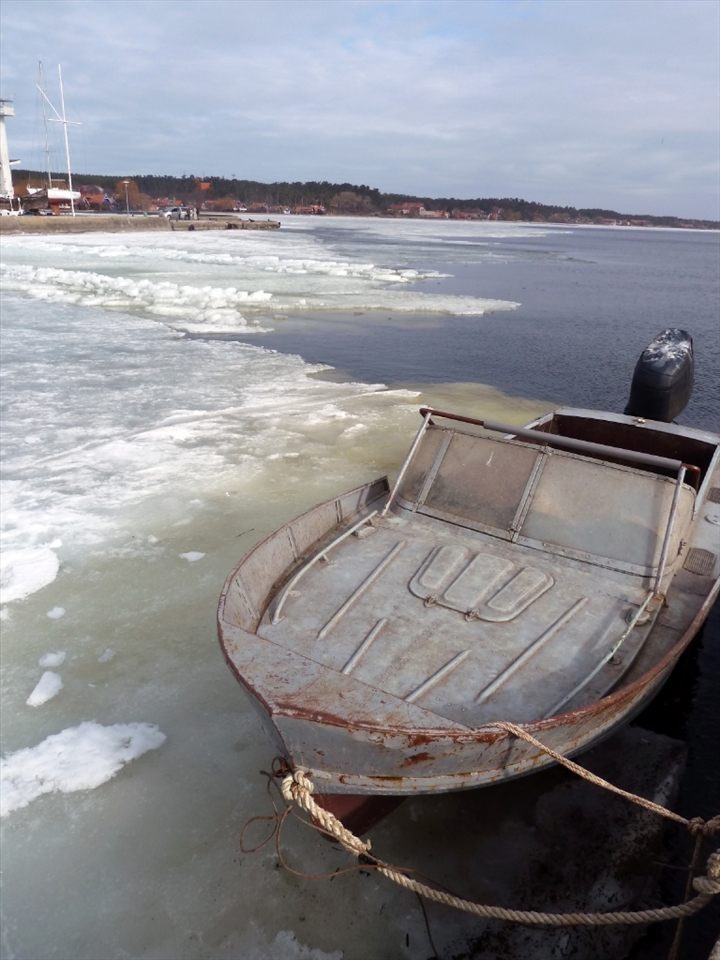 When the boats become locked in by ice, fishermen in Nida carry on by building ice-fishing shanties and catching smelt by the boatload.

* The photo is of one of the boats docked in the lagoon shortly after the ice has receded in the spring.