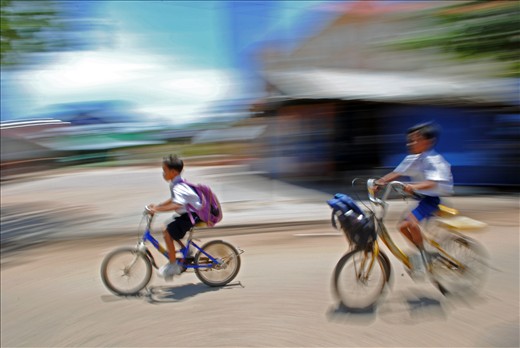 Two young boys make their way home from school in Siem Reap. Photo by: Matt Boss