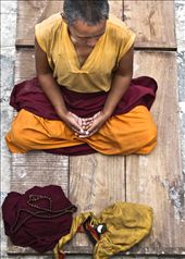 Everyday around the Bouddhanath stupa, monks, nuns, tourists and the ordinary people start their day by practicing Buddhism in different ways. The nun in the picture is meditating after the prostration practice.: by bouddhanath, Views[562]