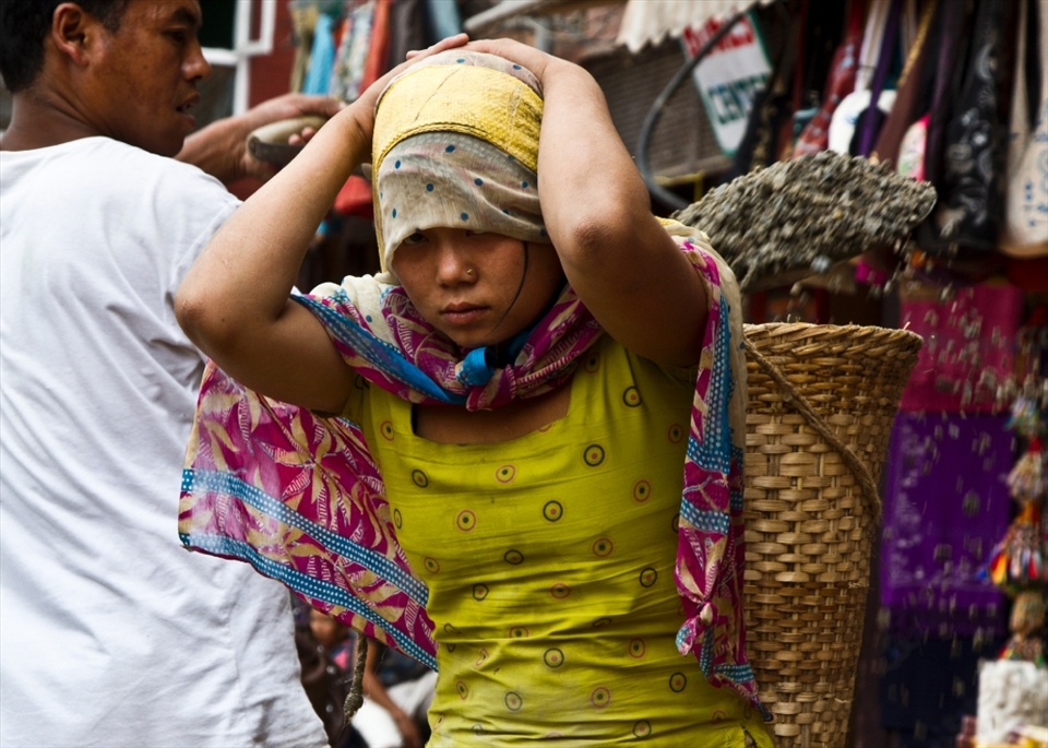 One of the surprising scenes one might encounter in Nepal is the women labor for building constructions. In Nepal women work even harder than men when it comes to construction, however they are paid less. They carry heavy loads of construction materials while bearing most of the weight on their forehead. The young girl in the picture was working in a construction site around the Bouddhanath.