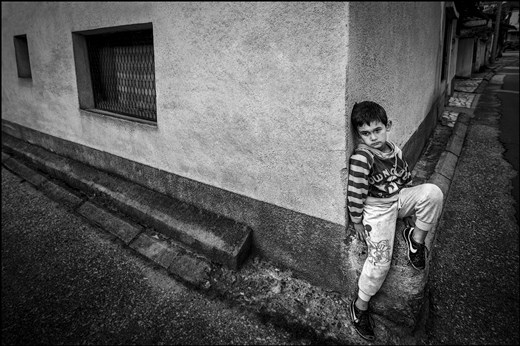 A little boy in deep thoughts till he waits his mother to come back from work