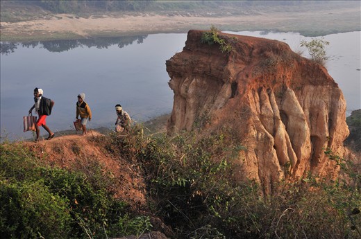 Tribal people ascend from river bed and overcome the barrier of 