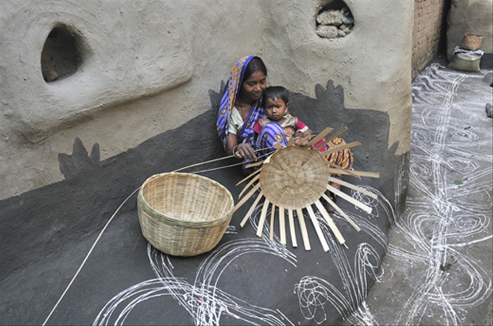 A lady looks after her little baby during her work during this festival season.