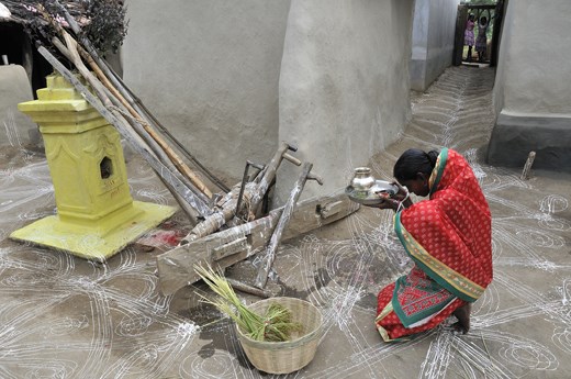 The housewife offers prayer to sacred 