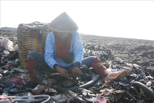 One of the scavengers sitting on the rubbish quietly and working diligently to collect old shoe soles said, “The life in this place is pretty difficult indeed, I cannot get definite income every day and it depends on how hard I work collecting this stuffs.” Just using old rusty knife, dirty basket for putting the goods, and poor outfit with traditional hand-made straw hat on his head to prevent hot sun light hitting the face, he does his job patiently without any proper safety equipment like gas mask and rubber boots; the interesting matter is that he realizes living in this such environment shorten his life because the exposure of the gas causes chronic lung diseases, headache, harmful skin diseases and other similar health problems. “The fact is I must work in this way to sustain my family needs,” he said.