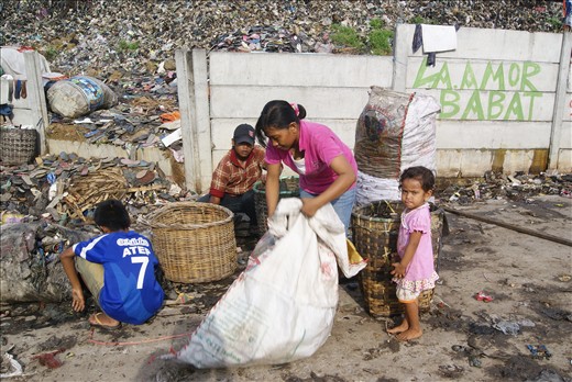 Like brick, stone, cement and other building material connected each other to create sole strong house, so do a father, his wife, son and two-year old young daughter have to gather the “fresh” rubbish and carry it to the nearest fence. This photo was taken at 6.30 am in the early morning reflecting the hard work of the rigid solid family supporting each other and working hand in hand agreed to make a living together, in this rare slum area. 