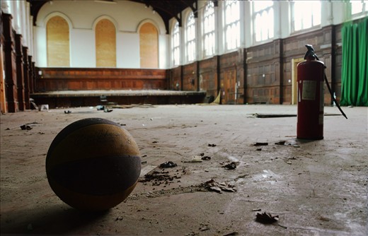 An uneasy quiet in an abandoned shool hall that was once filled with life.