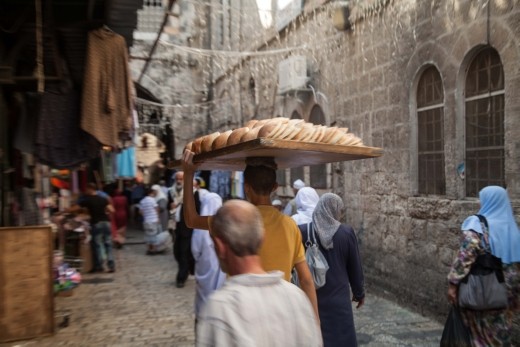 A local baker transporting the mornings bread through the narrow streets of The Christian Quarter of Jerusalem.