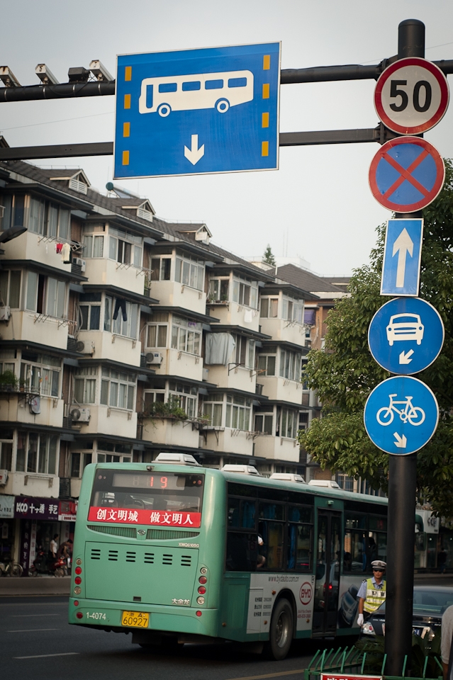 A mostly-empty bus, soon to be sagging with people when the workday ends.