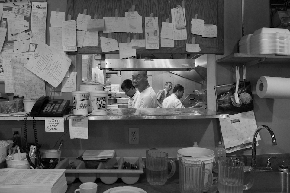The view into the kitchen from the waitress station.  The area is littered with 30 years of notes, reminders and numbers.