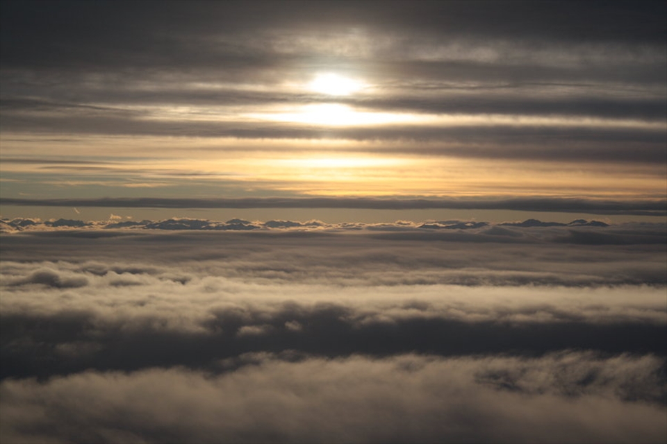 The sun setting in the clouds above Christchurch, Canterbury, NZ, as I descend in a plane. You might not guess that this was simply taken through the porthole window. This photo was taken before the first quakes in Chch. The plane descent is symbolic of the fall of the city and it's most beautiful buildings. The absence of any structures in this image is important also, showing that Chch doesn't need those buildings to be beautiful.