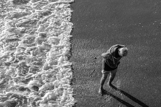 An elderly man enjoying the ocean at the Santa Monica pier in California 