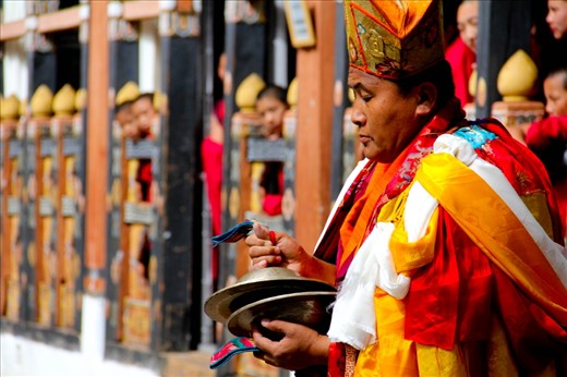 Head Monk - Bhutan is known for it's amazingly vibrant festivals. I was lucky enough to travel to Bhutan in October 2011 and was deeply touched by this beautiful serene Buddhist kingdom. These images are all taken from a local festival at the Paro Dzong. I have chosen these particular 5 images to depict the regious and cultural elements the festival brings together. In this picture, one of the head monks solemly clashes his instrument as he leads out the procession.