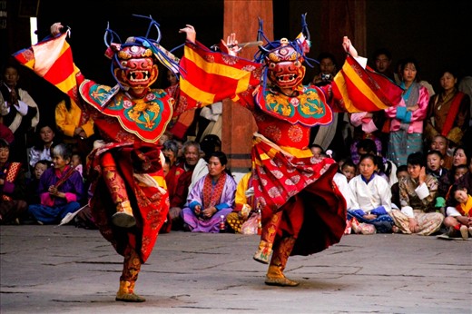 Local Dance - The locals, as seen in the background, attend the festival in their finest clothes - the brightly coloured silk Kira for the women and the Gho for the men. The dancing at the festivals is enegetic and hypnotic.