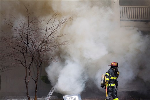A Minneapolis firefighter surveys the area, checking to make sure there is no chance the fire can return.