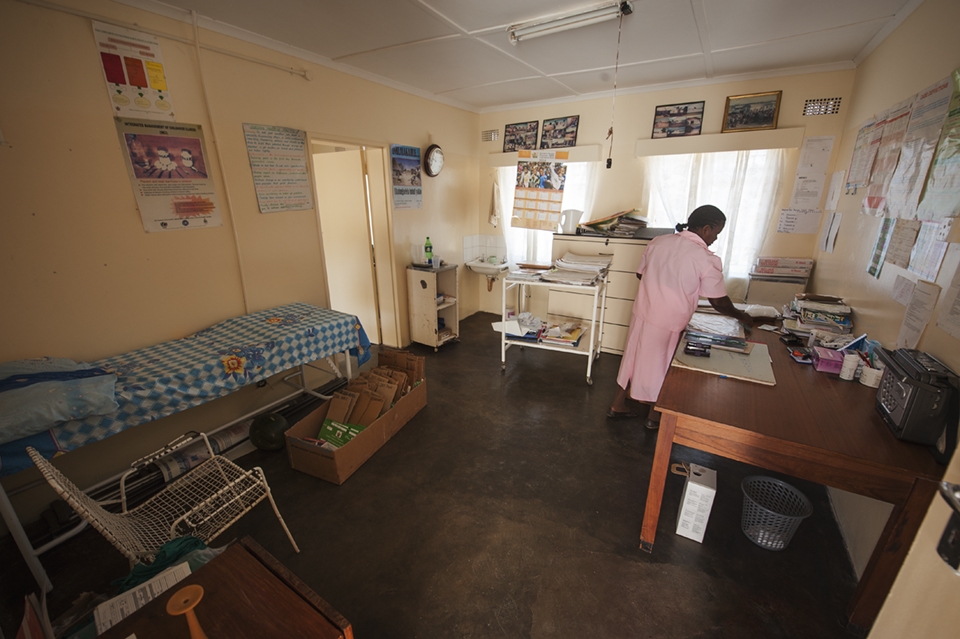 A nurse prepares her room before patients arrive, she can see up to 60 per day. Resources are extremely low, even the patient records are detailed and separated by bits of cardboard as seen here.