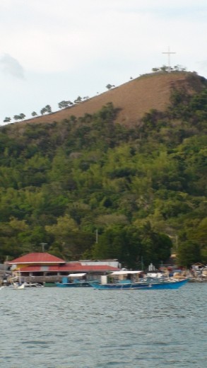 Coron Divers new shop and bankas in the foreground on the water in Coron Town