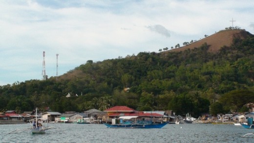 Coron Divers new shop and bankas in the foreground on the water in Coron Town