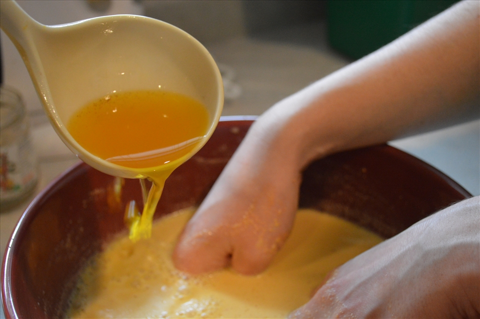 Adding golden stock to the almond/egg mixture. 