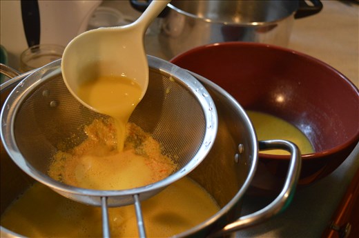 Sieving the mixture before the final cooking step. 