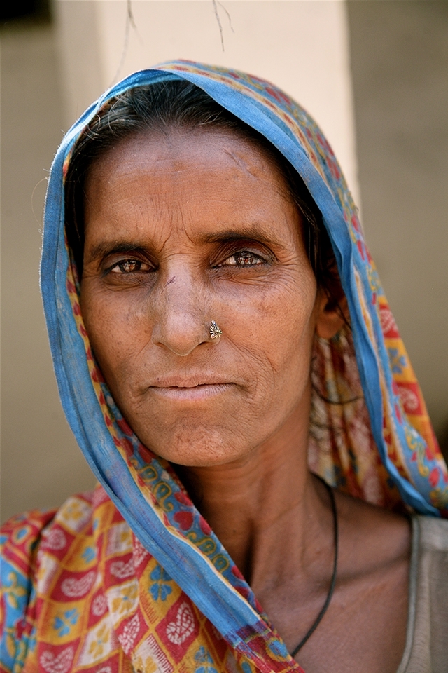 Years of living in slum conditions have left this woman worn by days of hard work and uncertainty, slums are illegal dwellings, and temporary, nothing is ever stable, her home, food, clean water. They are only there as long as a blind eye is turned, but they are regularly moved on, usually where they can be hidden from sight.