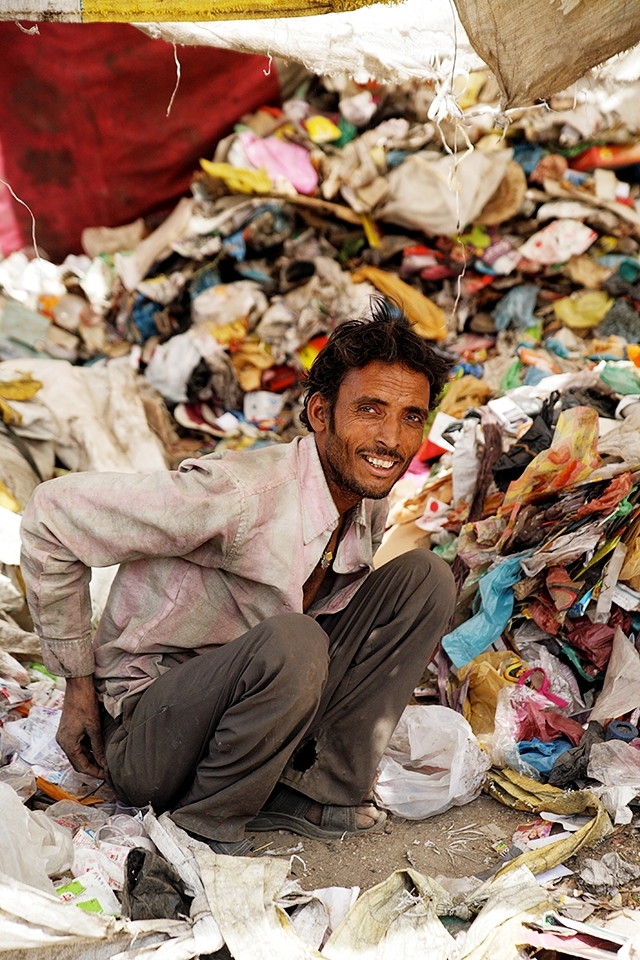 A rag picker, sifts through rubbish to find items that can be resold. He has four children and a wife to provide for. 