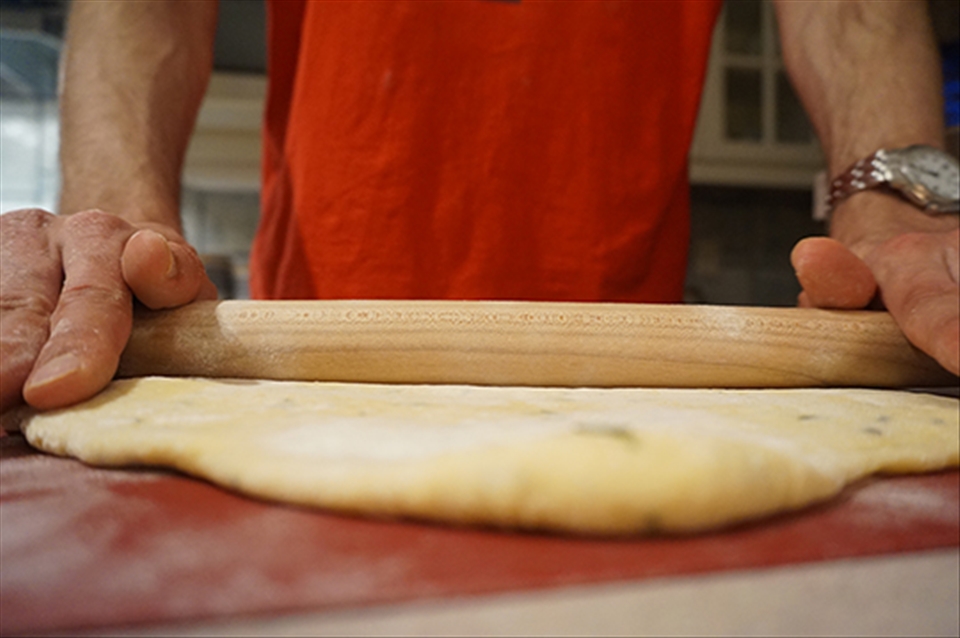 Rolling out the dough.