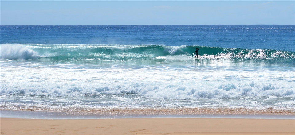A surfer of the NSW Coast enjoys the ride.