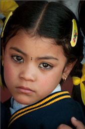 A young Nepalese girl, dressed in her school uniform. She attended the same private school in Kathmandu that the orphans I worked with went to, many of them on generous scholarships. Like many children in Kathmandu, the kohl around this girl's eyes is not only applied for aesthetic reasons but to protect her against the evil eye.  : by captivate, Views[3026]