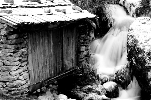 On the second day of my Everest trek, I came across this old abandoned water mill, laden with snow. The small water cascade still flows underneath it. 