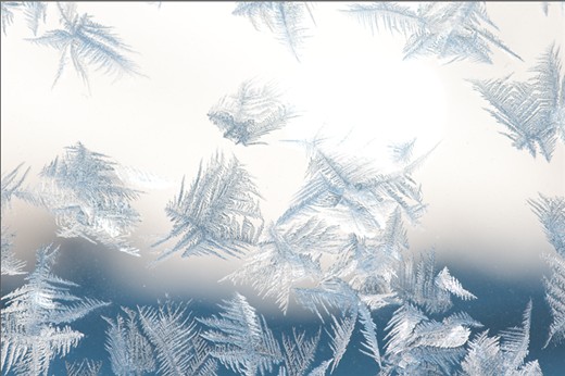 At over 4000 m and suffering from the throes of altitude sickness, I awoke on the third day of my Everest trek to this beautiful sight: crystallised ice laced onto the glass of the window next to my bed in sprawling, intricate patterns. In the background, the blurred outlines of distant Himalayan peaks can be seen.