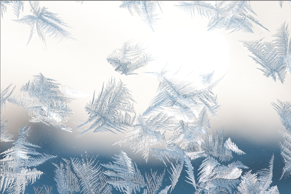 At over 4000 m and suffering from the throes of altitude sickness, I awoke on the third day of my Everest trek to this beautiful sight: crystallised ice laced onto the glass of the window next to my bed in sprawling, intricate patterns. In the background, the blurred outlines of distant Himalayan peaks can be seen.