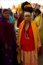As I roamed about the lanes of the makeshift 'Kumbh City' searching for the Sadhavi (Female Sadhu) camps someone told us about, I bumped into her. Long matted hair tied up in a bun, a cigarette in hand, she spoke of living life without materialistic burdens. Here she proudly poses for my camera as a lady vendor selling amulets looks on. She hailed from Guwahti in eastern India.
Female Sadhus or 'sadhavi' as they are called, form a small but significant group at Kumbh.: by capturedincameraobscura, Views[628]