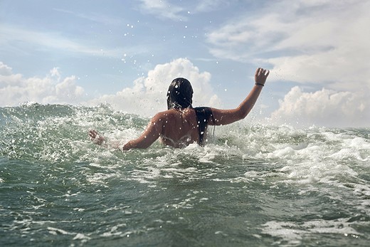 A girl go to swiming in the Empuriabrava beach