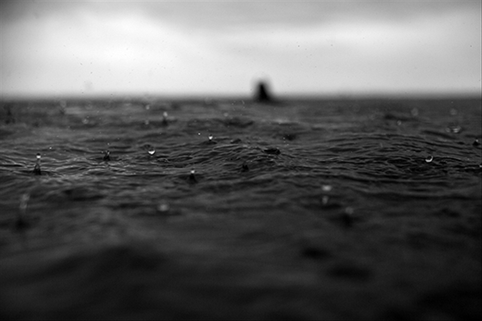 Detail of the drops of rain falling down the sea