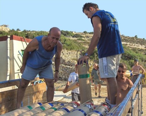 Here the band of brothers have joined forces in order to give a helping hand in loading the petards onto the truck to be carried to their final destination. Great tension can be observed on the faces of these men who have worked for months to create these fine fire flowers and waiting in anxiety for the evening show to see the outcome of their endavours.