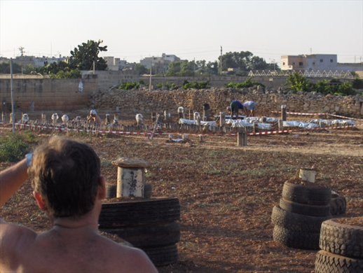 The canon pipes are being loaded and connected to each other for the evening show. On these days, temperatures can go over 35 degrees Celcius. My dad having just arrived with his petards and unloaded them from the truck, overlooks the work and moves in to give a helping hand to his comrades