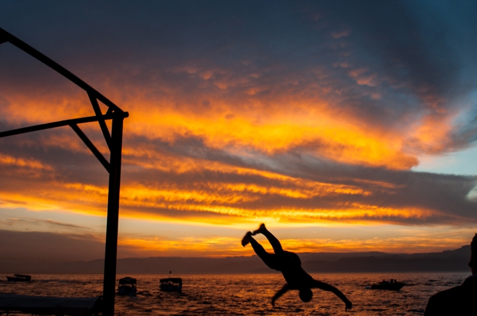 Sunset in Aqaba beach. The children had some fun diving from the structure above.